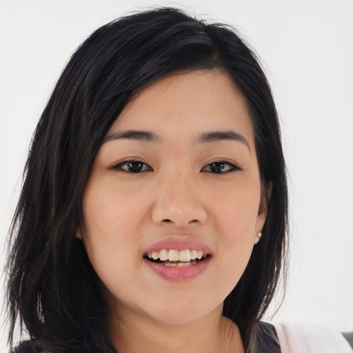 Joyful asian young-adult female with long  black hair and brown eyes
