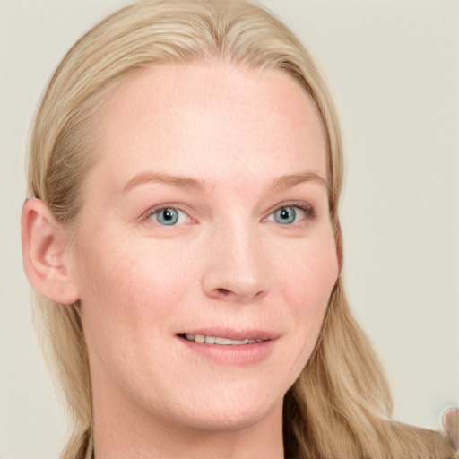 Joyful white young-adult female with long  blond hair and blue eyes