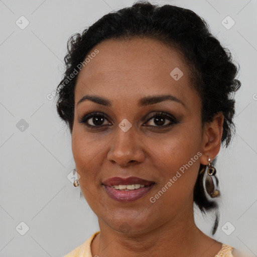 Joyful black adult female with short  brown hair and brown eyes