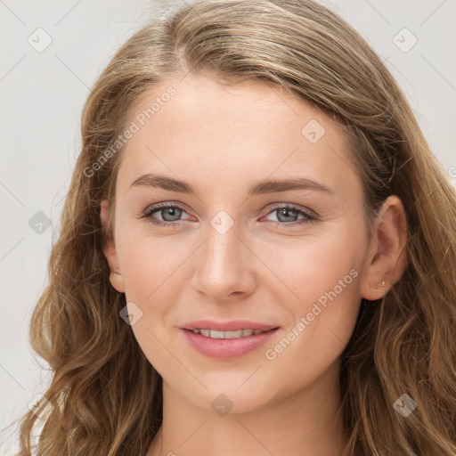 Joyful white young-adult female with long  brown hair and blue eyes