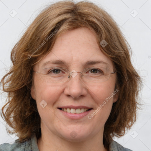 Joyful white adult female with medium  brown hair and blue eyes