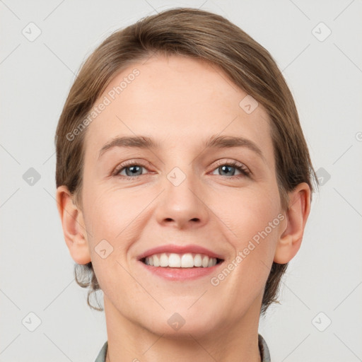 Joyful white young-adult female with short  brown hair and grey eyes