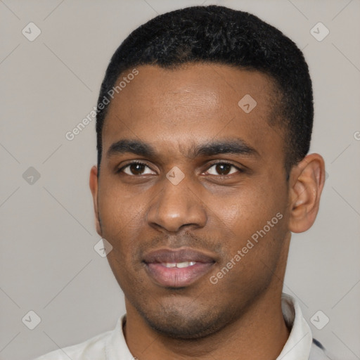 Joyful black young-adult male with short  black hair and brown eyes