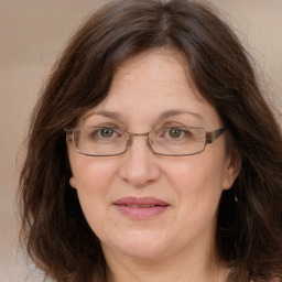 Joyful white adult female with long  brown hair and brown eyes