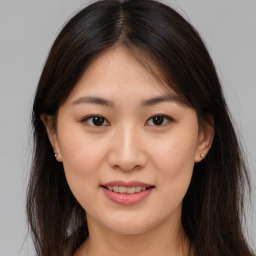 Joyful asian young-adult female with long  brown hair and brown eyes