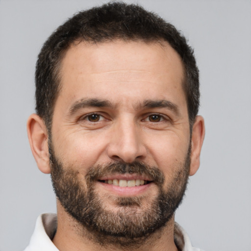 Joyful white adult male with short  brown hair and brown eyes