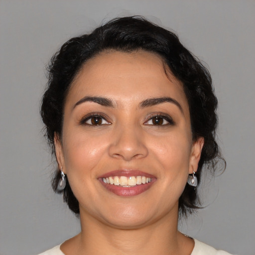 Joyful latino young-adult female with medium  black hair and brown eyes
