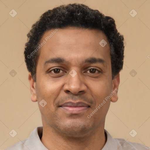 Joyful latino young-adult male with short  brown hair and brown eyes