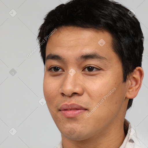 Joyful asian young-adult male with short  black hair and brown eyes