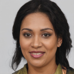 Joyful black adult female with medium  brown hair and brown eyes