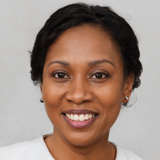 Joyful black adult female with medium  black hair and brown eyes