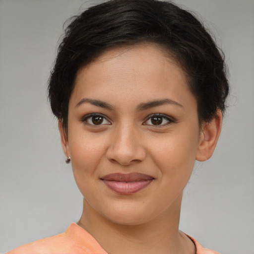Joyful latino young-adult female with short  brown hair and brown eyes