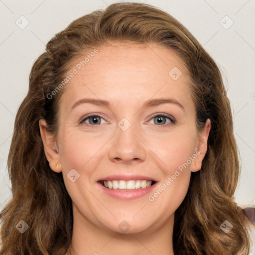 Joyful white young-adult female with long  brown hair and blue eyes