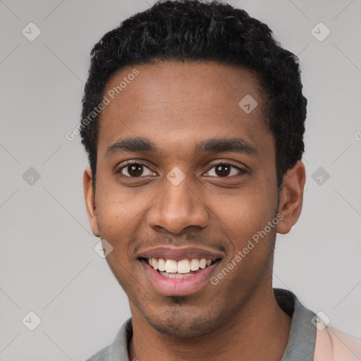 Joyful black young-adult male with short  black hair and brown eyes