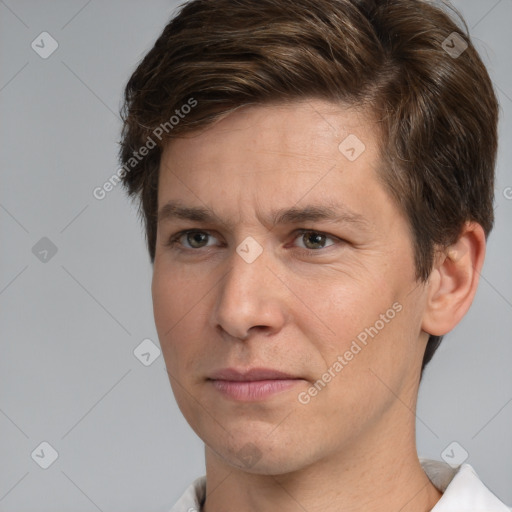 Joyful white adult male with short  brown hair and brown eyes