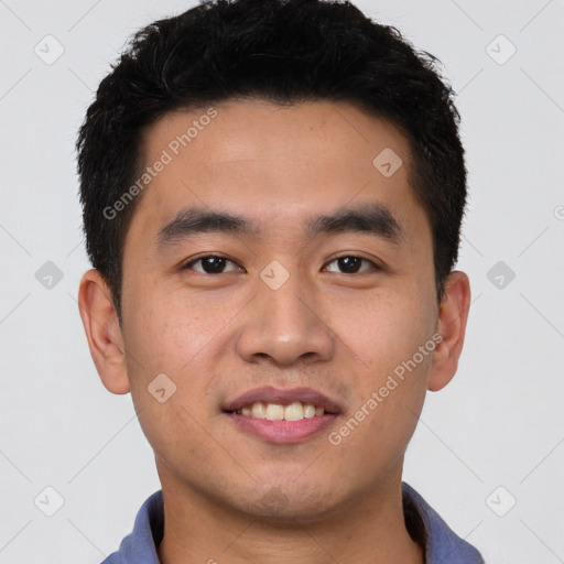 Joyful latino young-adult male with short  brown hair and brown eyes