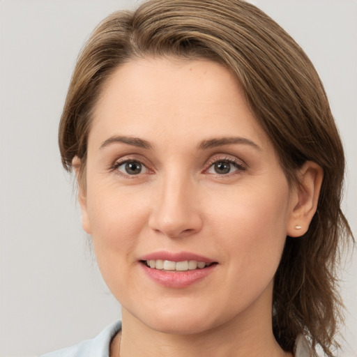 Joyful white young-adult female with medium  brown hair and brown eyes