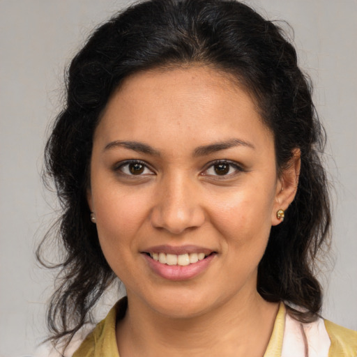 Joyful latino young-adult female with medium  brown hair and brown eyes