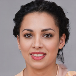 Joyful latino young-adult female with medium  brown hair and brown eyes