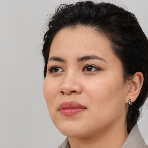 Joyful asian young-adult female with medium  brown hair and brown eyes