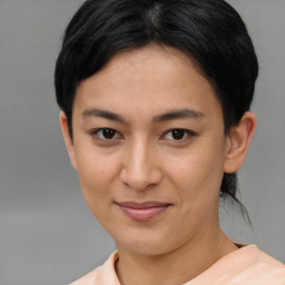 Joyful asian young-adult female with short  black hair and brown eyes