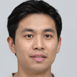 Joyful asian young-adult male with short  black hair and brown eyes