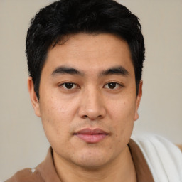 Joyful asian young-adult male with short  black hair and brown eyes