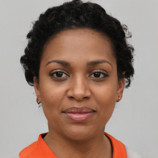 Joyful black young-adult female with short  brown hair and brown eyes