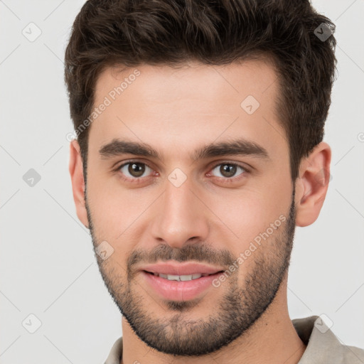 Joyful white young-adult male with short  brown hair and brown eyes