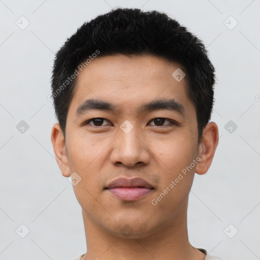 Joyful asian young-adult male with short  black hair and brown eyes