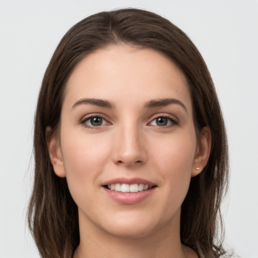 Joyful white young-adult female with long  brown hair and grey eyes