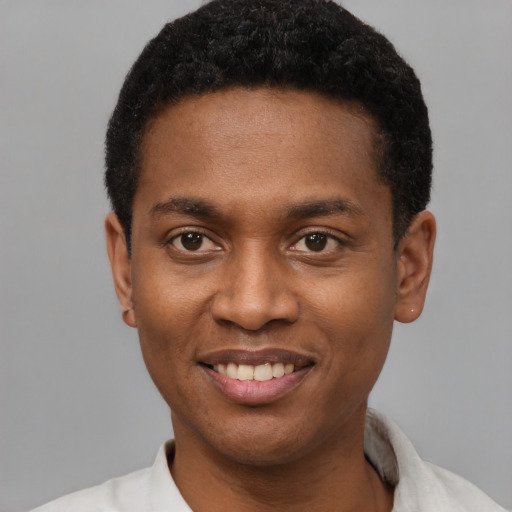 Joyful black young-adult male with short  black hair and brown eyes