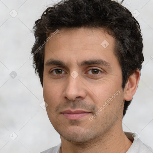 Joyful white adult male with short  brown hair and brown eyes