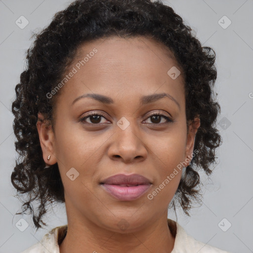 Joyful black adult female with medium  brown hair and brown eyes