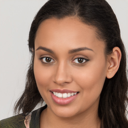 Joyful white young-adult female with long  brown hair and brown eyes