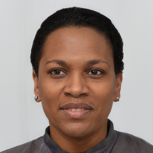 Joyful black young-adult female with short  black hair and brown eyes
