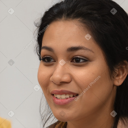 Joyful latino young-adult female with long  brown hair and brown eyes