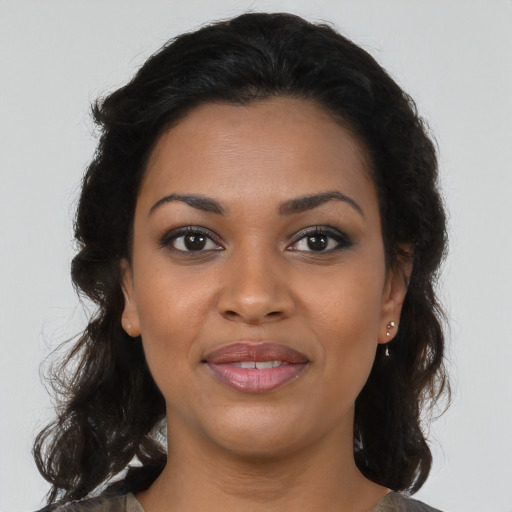 Joyful black young-adult female with medium  brown hair and brown eyes