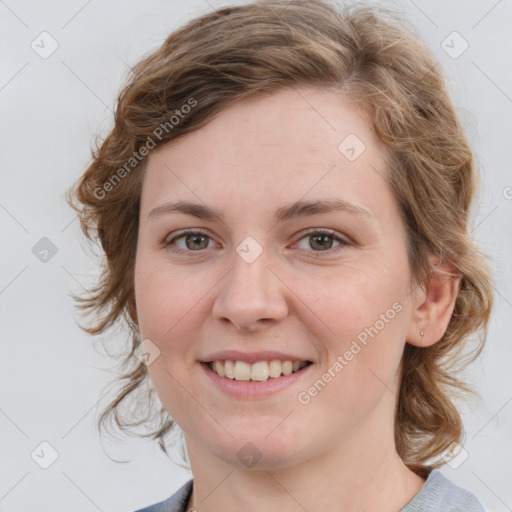 Joyful white young-adult female with medium  brown hair and blue eyes