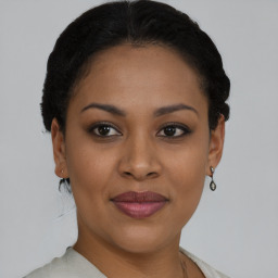 Joyful black young-adult female with short  black hair and brown eyes
