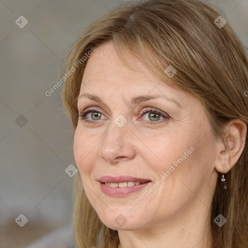 Joyful white adult female with medium  brown hair and grey eyes