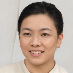 Joyful asian young-adult female with short  brown hair and brown eyes