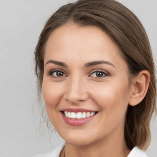 Joyful white young-adult female with long  brown hair and brown eyes