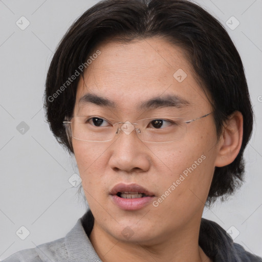 Neutral asian adult male with medium  brown hair and brown eyes