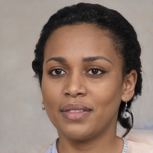 Joyful black young-adult female with medium  black hair and brown eyes