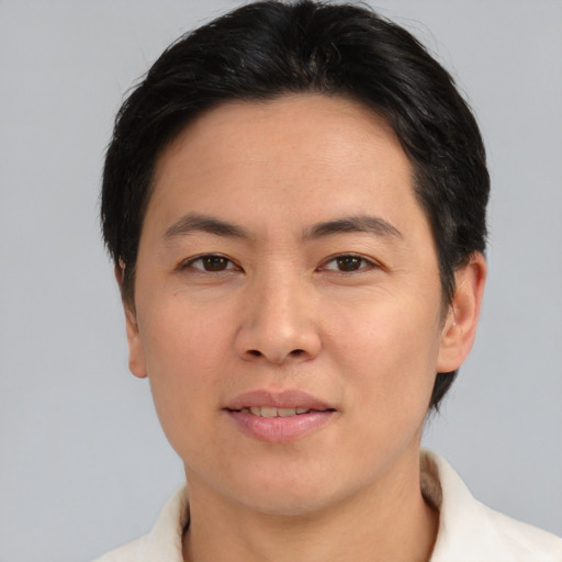Joyful asian adult male with short  brown hair and brown eyes