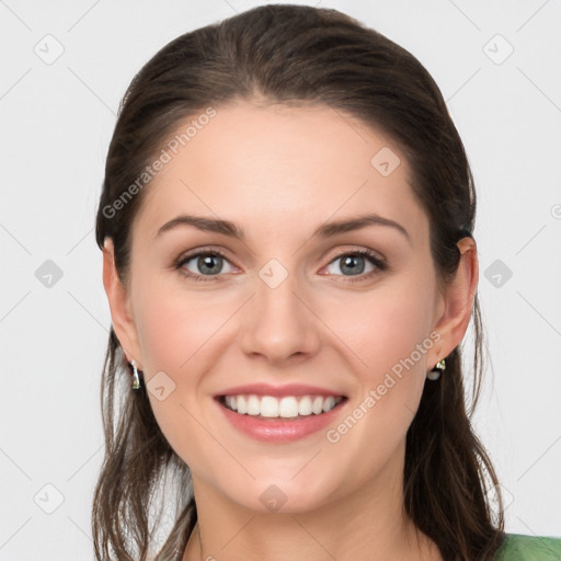 Joyful white young-adult female with long  brown hair and green eyes