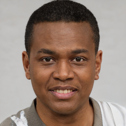Joyful latino young-adult male with short  brown hair and brown eyes