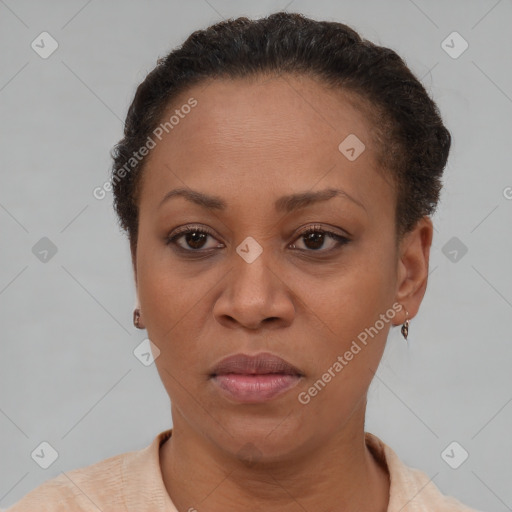 Joyful latino adult female with short  brown hair and brown eyes
