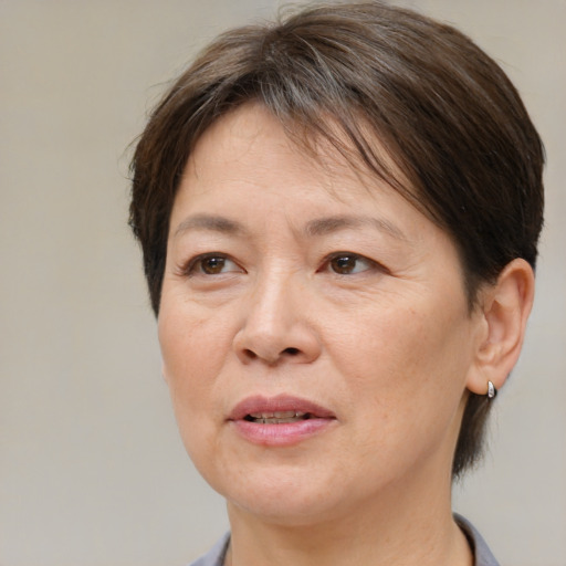 Joyful white adult female with short  brown hair and brown eyes